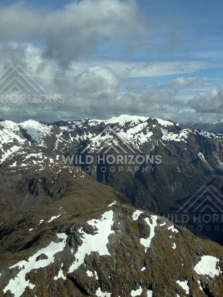 High Fiordland Ridges Under Broken Cloud. Fiordland, New Zealand.