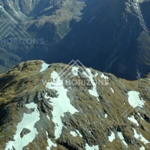 Steep Fiordland Cliffs and Snow Streaks. Fiordland, New Zealand.