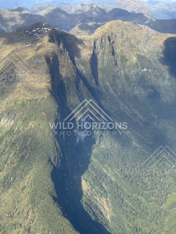 Deep Fiordland Valley and Sheer Slopes. Fiordland, New Zealand.