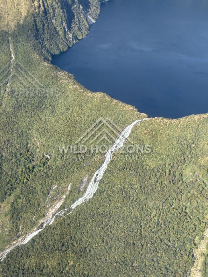 Waterfall and Lake in Fiordland. Fiordland, New Zealand.