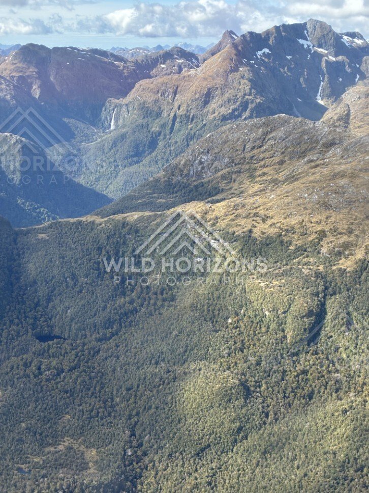 Sunlit alpine ridges and deep valleys. Fiordland, New Zealand.