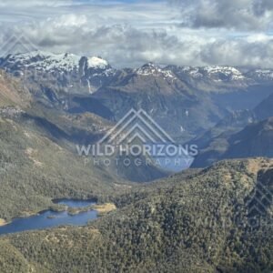 Long Fiordland lake winding through forested valleys. Fiordland, New Zealand.