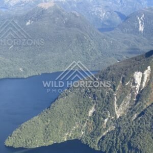 Deep Fiordland lake enclosed by steep forested slopes. Fiordland, New Zealand.