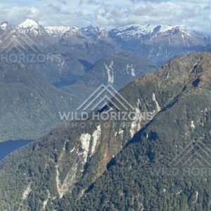 Mountain ridges above a long Fiordland lake. Fiordland, New Zealand.