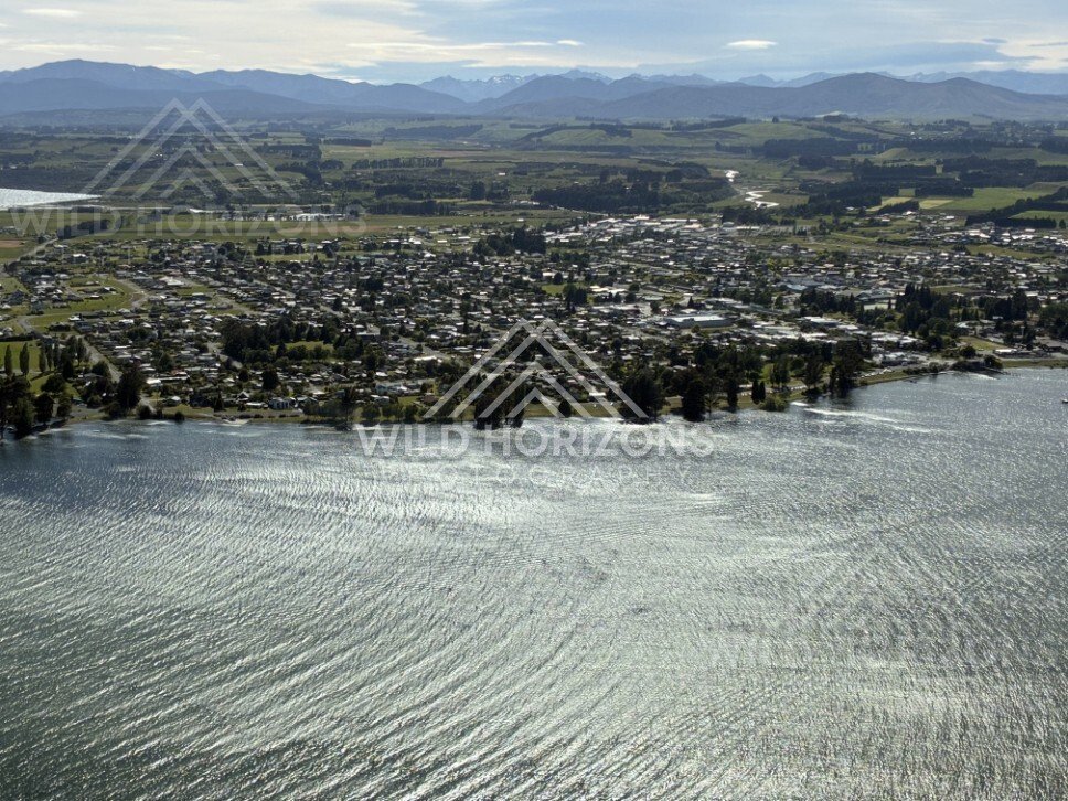 Lakeside township and shoreline seen from above. Manapouri, New Zealand.