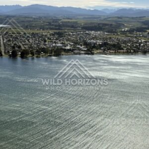 Wind-textured lake surface and lakeside settlement. Manapouri, New Zealand.