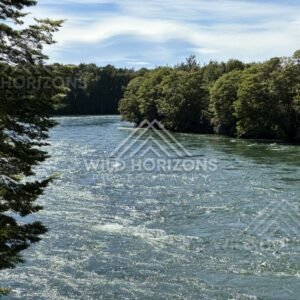Fast-flowing river with textured surface and forested banks. Manapouri, New Zealand.