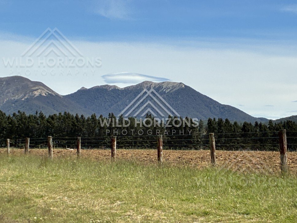 Open farmland with mountain backdrop. Rural Southland, New Zealand.