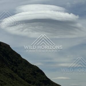 Lenticular cloud above mountain ridge. Kingston, New Zealand.