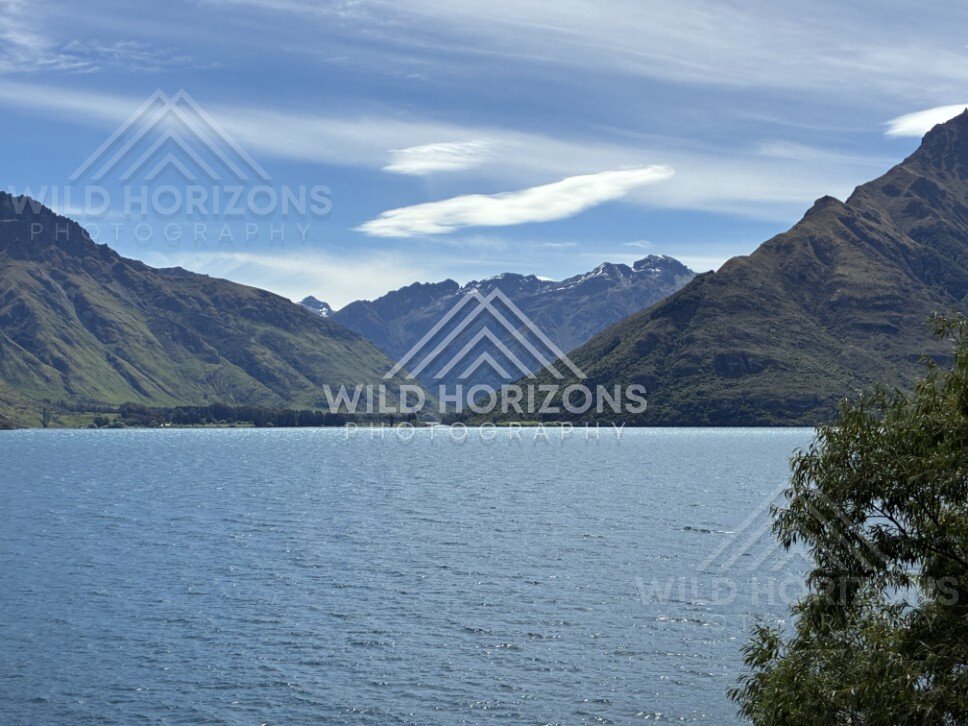 Wide lake view framed by steep mountain slopes. Kingston, New Zealand.