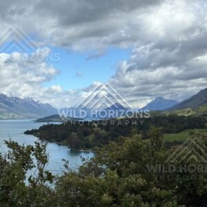 Lake and mountain landscape under bright broken cloud. Glenorchy, New Zealand.