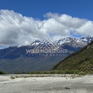 Gravel riverbed with snow-capped peaks beyond. Glenorchy, New Zealand.