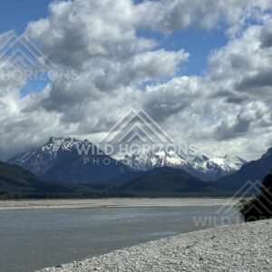 Lake with snow-capped peaks beneath broken cloud. Glenorchy, New Zealand.