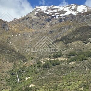 Mountain slope with winding waterfall. Glenorchy, New Zealand.
