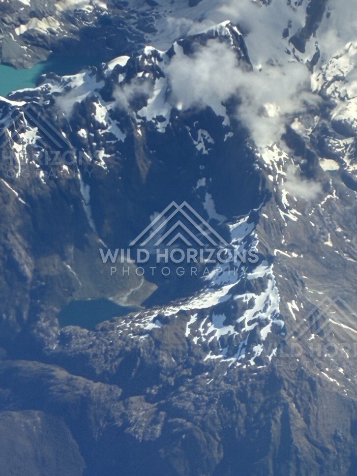 Snow-covered alpine peaks seen from above. Queenstown, New Zealand.