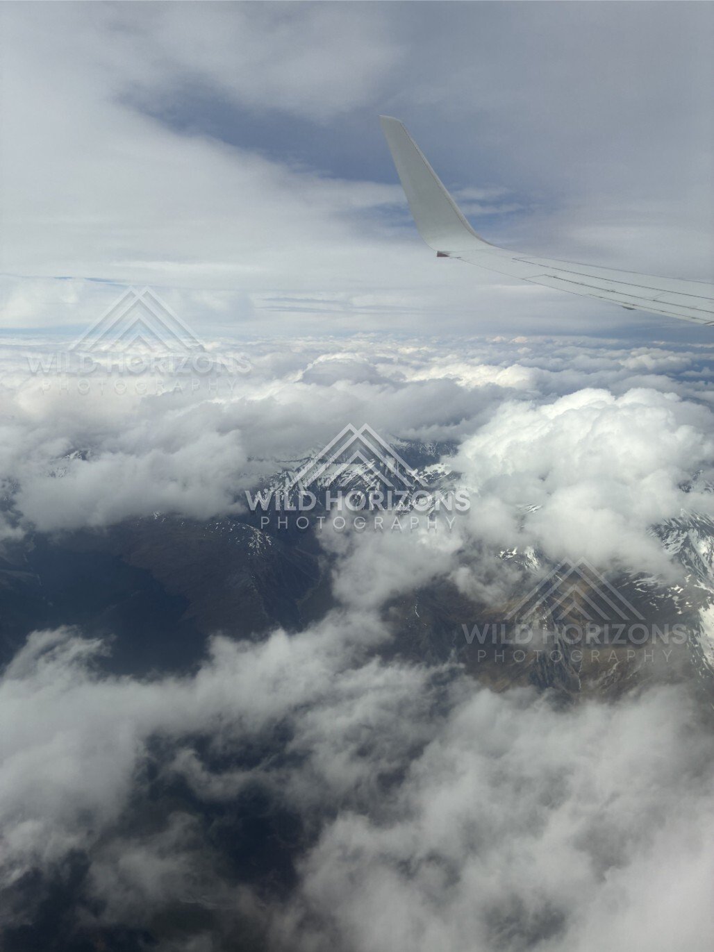 Aircraft wing above dense cloud cover. Queenstown, New Zealand.