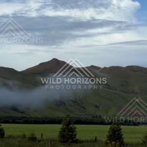 Low cloud drifting across green hills. Southland, New Zealand.