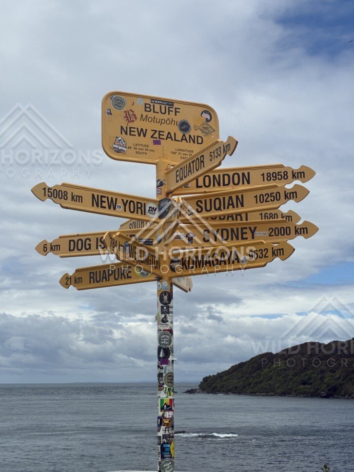 Signpost overlooking harbour at Bluff. Bluff, New Zealand.