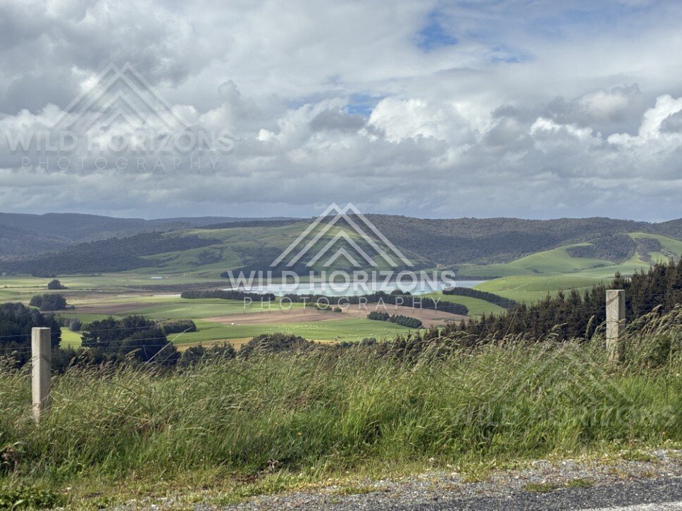 Rural valley with patchwork farmland and hills. Catlins, New Zealand.