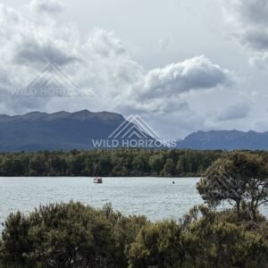 Small Boat on Lake Te Anau Under Heavy Clouds. Te Anau, New Zealand.