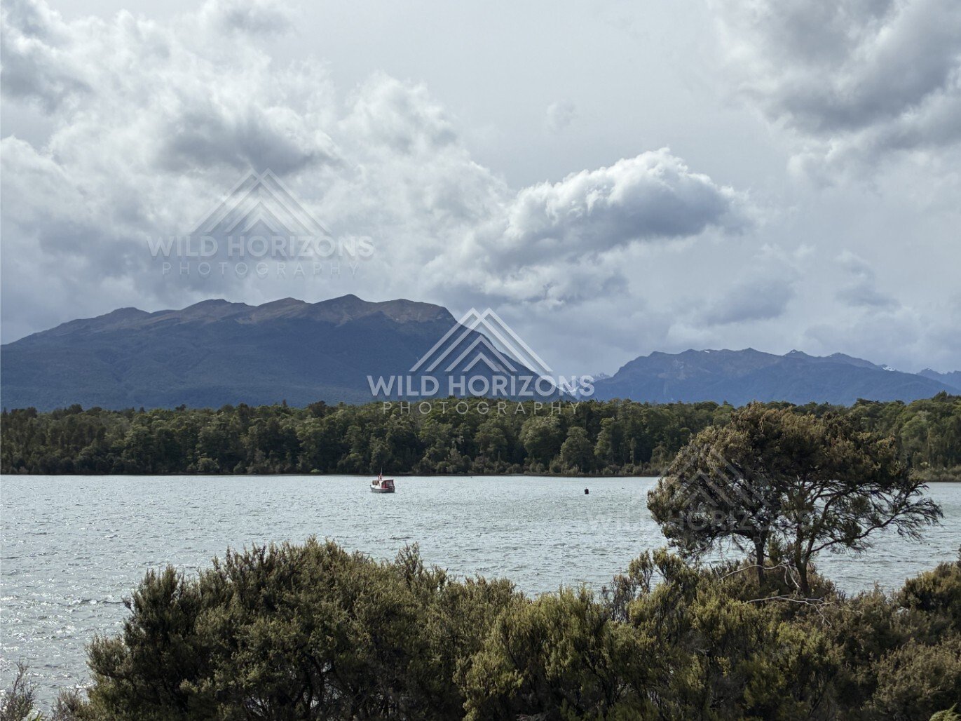 Small Boat on Lake Te Anau Under Heavy Clouds. Te Anau, New Zealand.