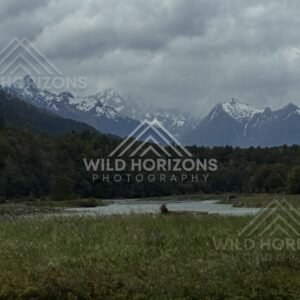 Storm Light Over the Eglinton Valley and Distant Snow Peaks. Milford Road, New Zealand.