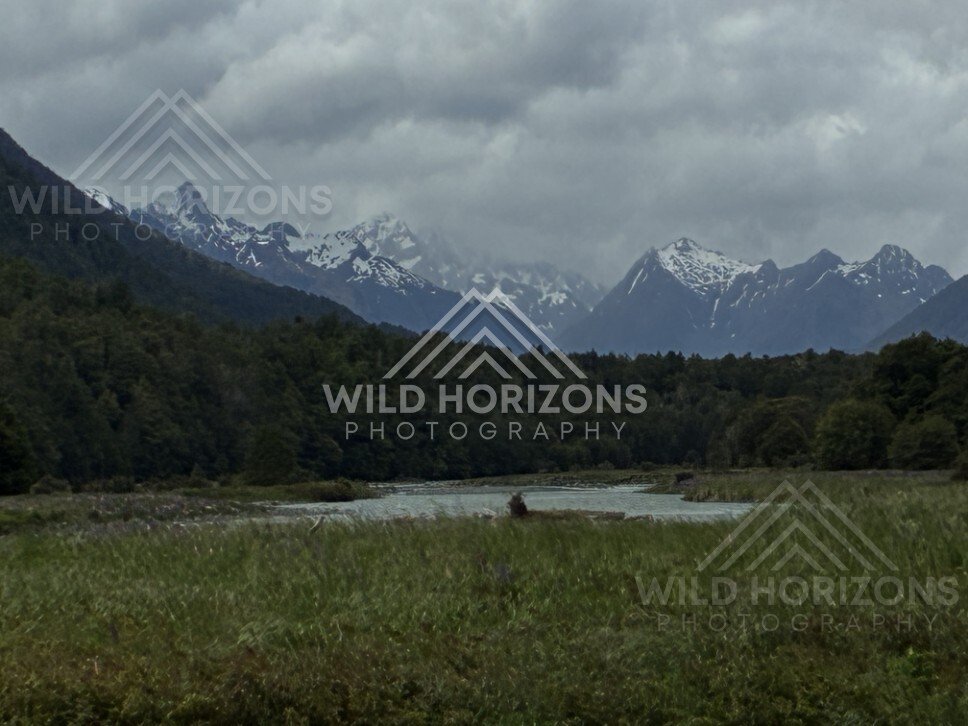 Storm Light Over the Eglinton Valley and Distant Snow Peaks. Milford Road, New Zealand.