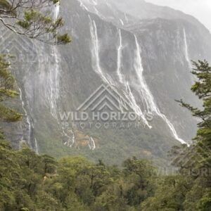 Sheer Fiordland Cliffs with Waterfalls in Wet Weather. Milford Road, New Zealand.