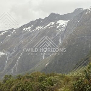 Jagged Fiordland Peaks with Thin Waterfalls After Rain. Milford Road, New Zealand.