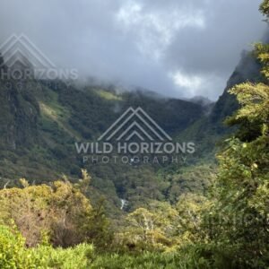 Cloudy Valley View with a Stream in the Distance. Milford Road, New Zealand.