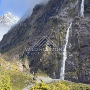 Sheer Cliff Face with Multiple Tall Waterfalls. Milford Road, New Zealand.
