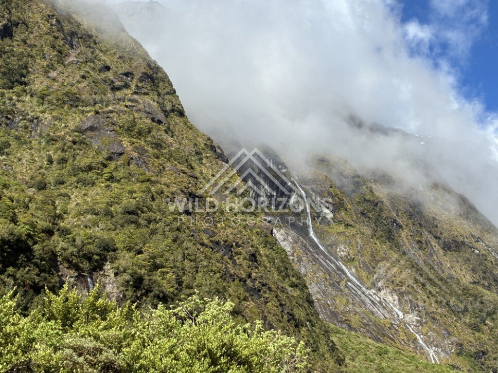 Multi-Tier Waterfalls on a Rugged Alpine Slope. Milford Road, New Zealand.