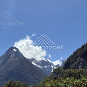 Mitre Peak and Snowy Ranges Under Clear Blue Sky. Milford Sound, New Zealand.