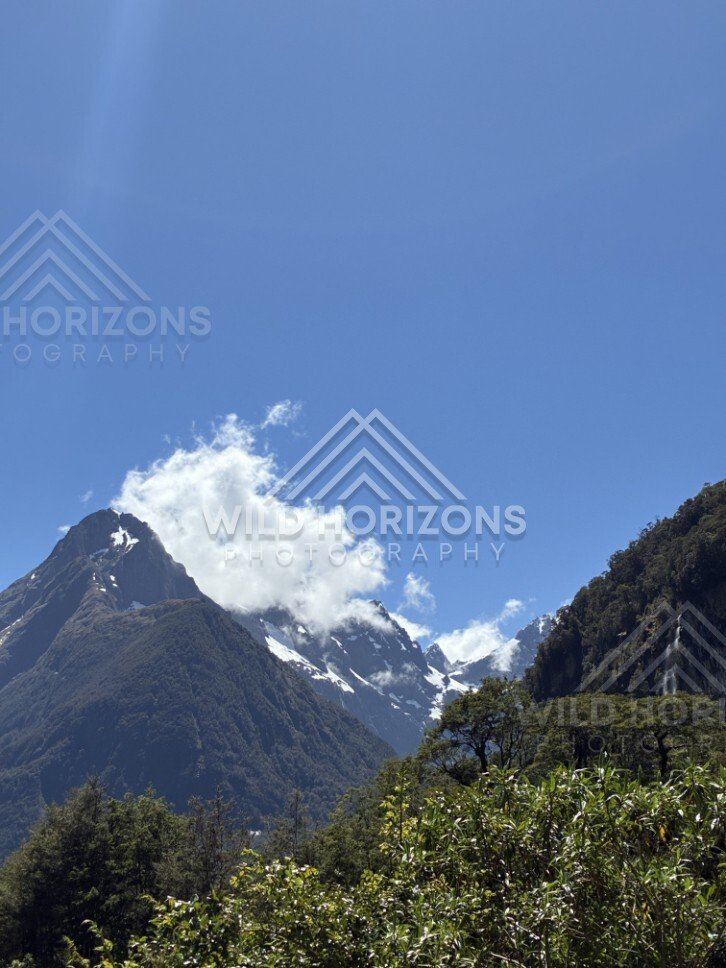Mitre Peak and Snowy Ranges Under Clear Blue Sky. Milford Sound, New Zealand.