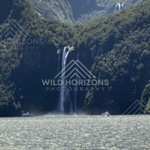 Twin Falls Plunging Into Milford Sound with Boats Below. Milford Sound, New Zealand.