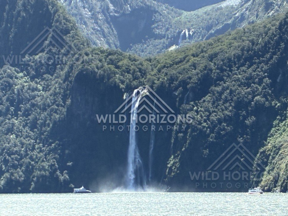 Tall Twin Waterfalls Framed by Steep Fiord Walls. Milford Sound, New Zealand.