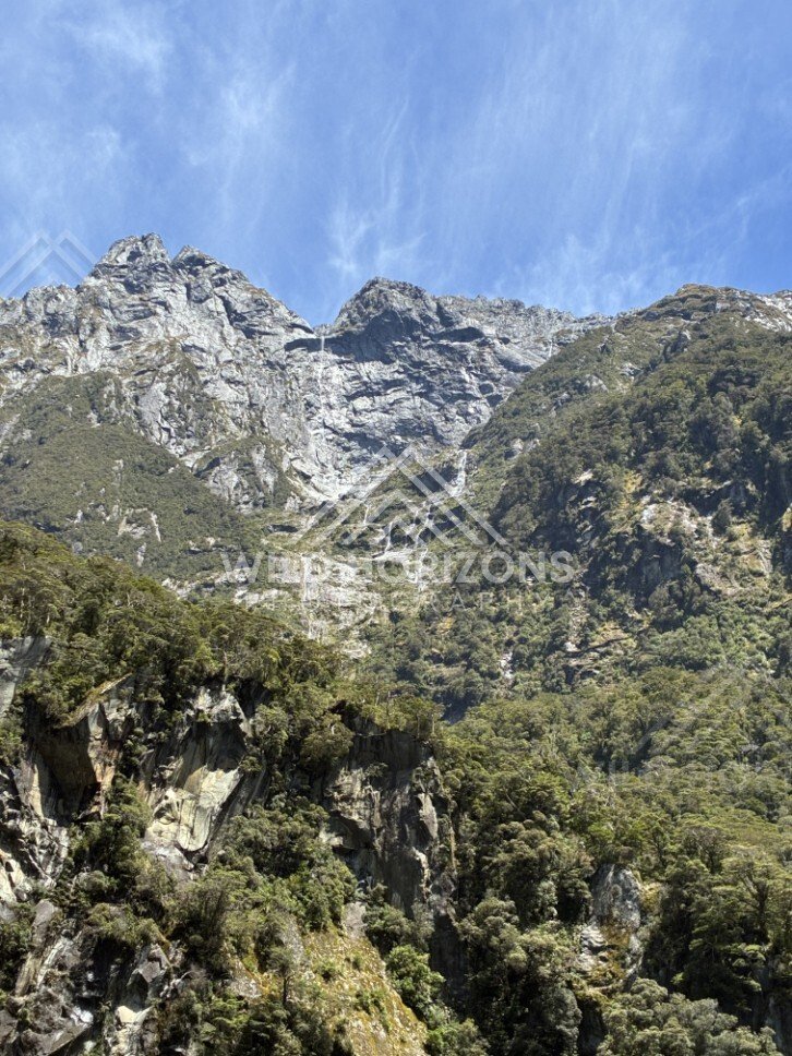 Alpine Peaks with Cascading Stream Down a Mountain Gully. Milford Sound, New Zealand.