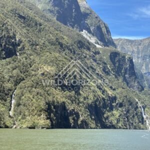 Fiord Wall and Waterway with Distant Waterfall Streaks. Milford Sound, New Zealand.