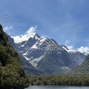 Alpine Valley and Snow-Dusted Peaks Under Clear Blue Sky. Milford Sound, New Zealand.