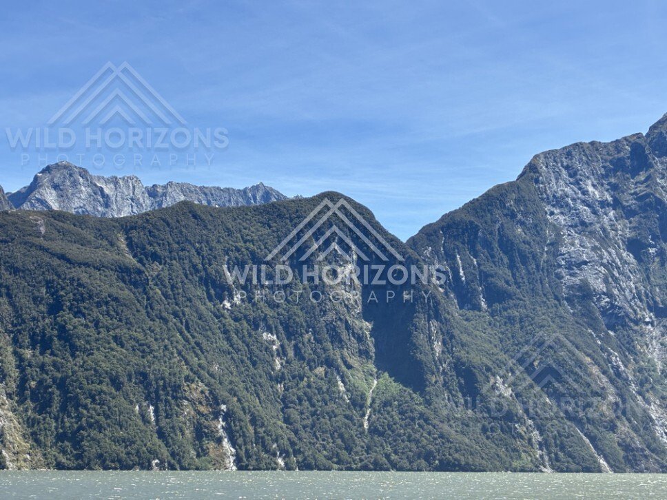Steep Mountain Wall Rising Above a Remote Fiord Landscape. Milford Sound, New Zealand.