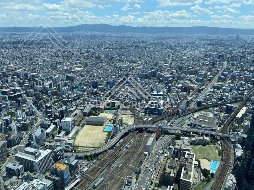 Aerial View Over Osaka with Highways, Rail Lines, and Dense City Blocks. Umeda Sky Building, Osaka, Japan.