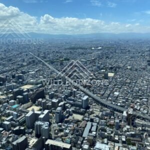Straight Rail Corridor and City Streets Running Through Central Osaka from Above. Umeda Sky Building, Osaka, Japan.
