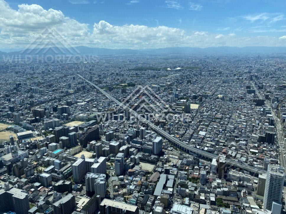 Straight Rail Corridor and City Streets Running Through Central Osaka from Above. Umeda Sky Building, Osaka, Japan.