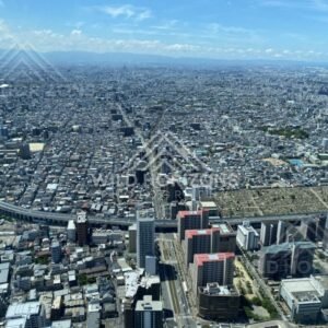 Wide Aerial Cityscape of Osaka with a Central Transit Corridor and Expressways. Umeda Sky Building, Osaka, Japan.