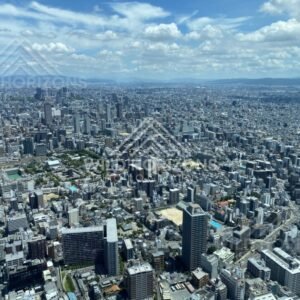 Sweeping Osaka Skyline Beneath Dramatic Cumulus Clouds from Above. Umeda Sky Building, Osaka, Japan.