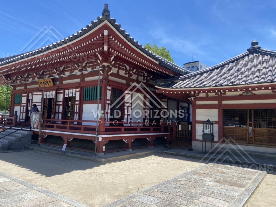 Traditional Temple Hall with Red Timber Architecture and Courtyard Stones. Shitennoji Temple, Osaka, Japan.