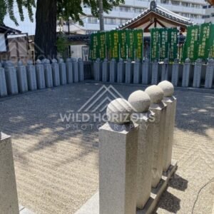 Stone Posts and Prayer Banners in a Quiet Temple Courtyard. Shitennoji Temple, Osaka, Japan.