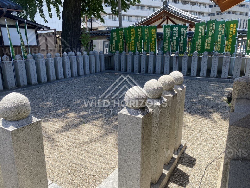 Stone Posts and Prayer Banners in a Quiet Temple Courtyard. Shitennoji Temple, Osaka, Japan.
