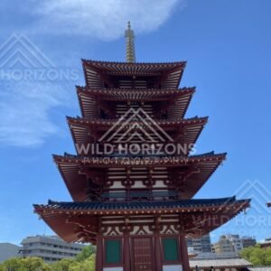 Front View of a Five-Story Pagoda with Ornate Eaves and Dramatic Sky. Shitennoji Temple, Osaka, Japan.