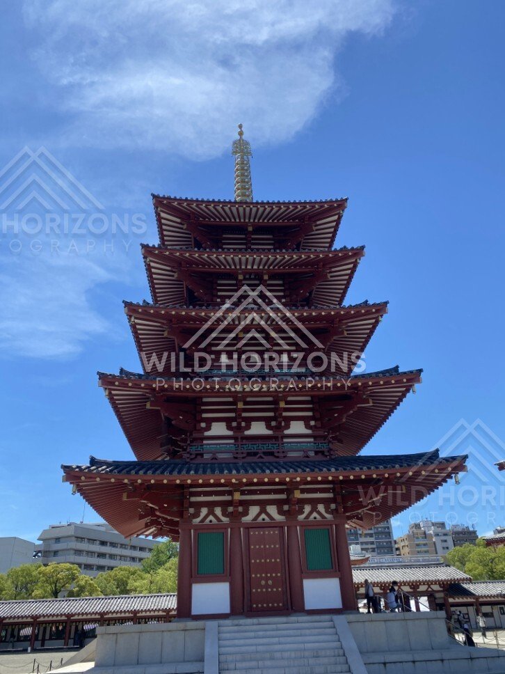 Front View of a Five-Story Pagoda with Ornate Eaves and Dramatic Sky. Shitennoji Temple, Osaka, Japan.